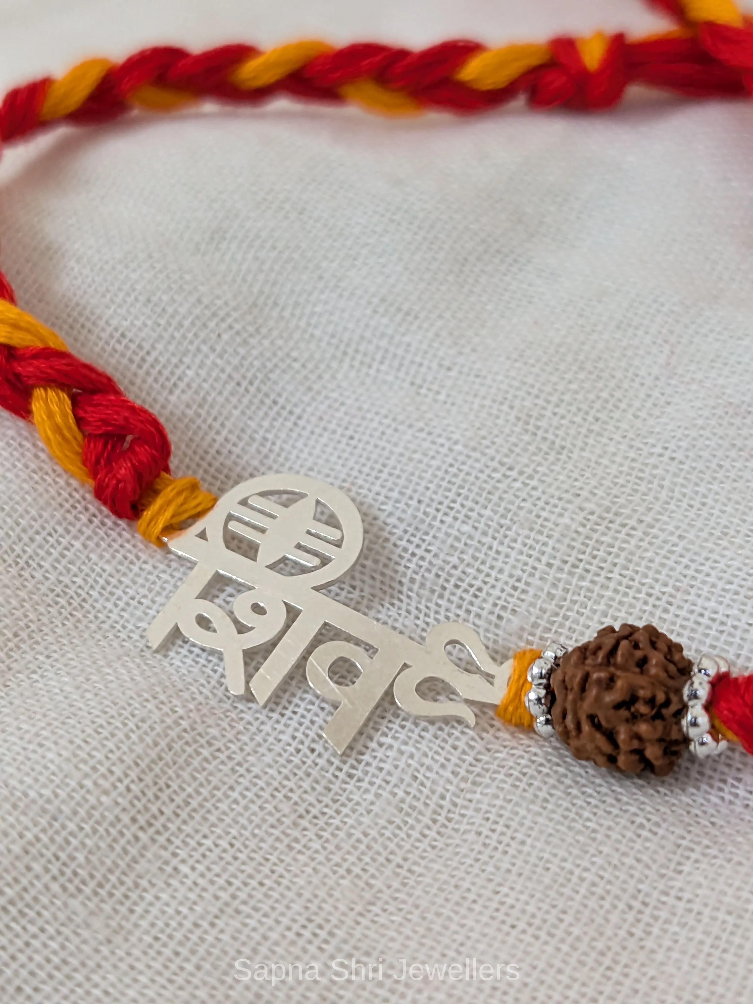 925 Silver Shiv Rudraksha Rakhi with Red & Yellow Mauli - Image 1 of 3 925 Silver Shiv Rudraksha Rakhi with Red & Yellow Mauli - View 1