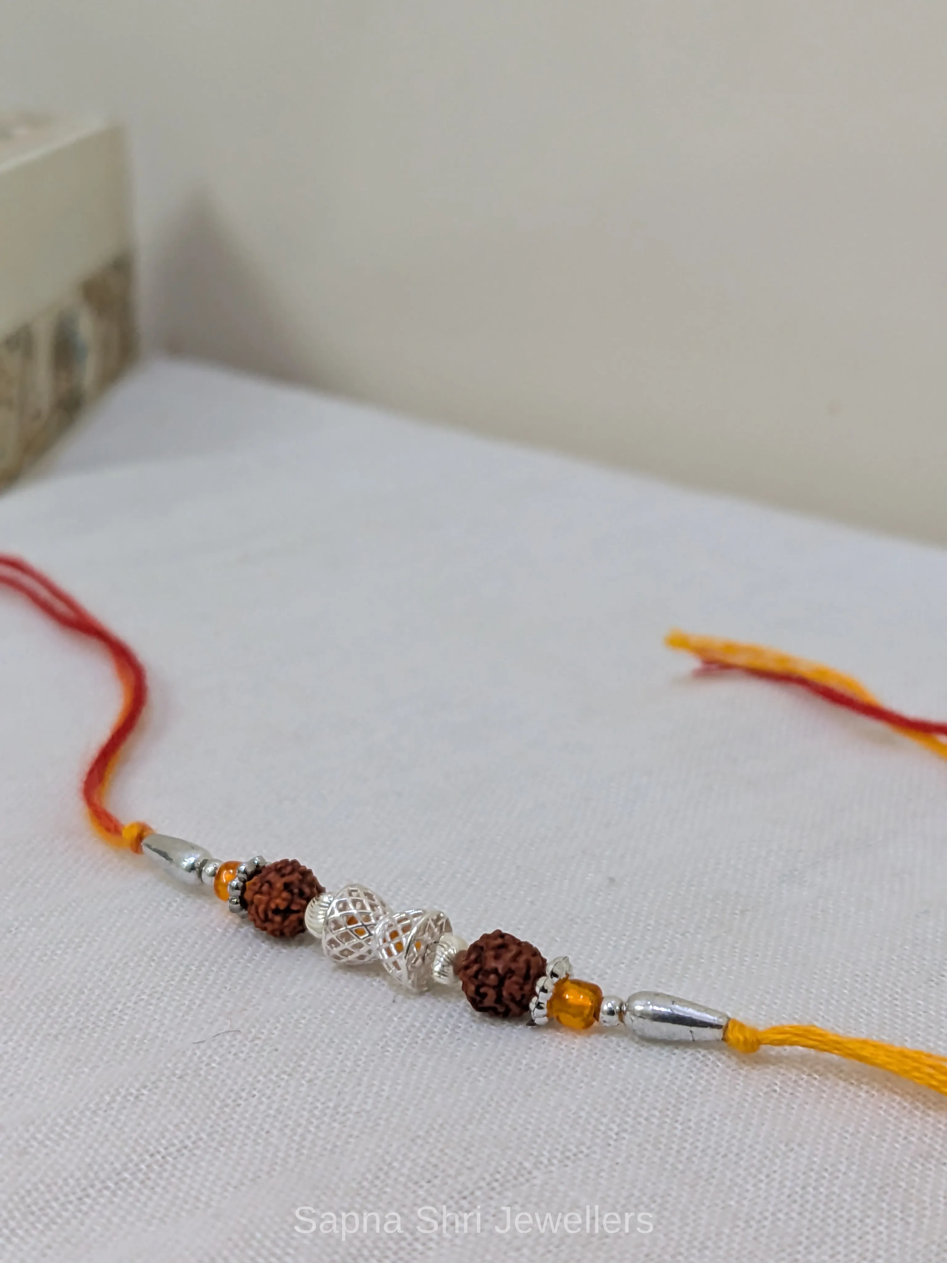 925 Silver Rudraksha Rakhi with Dual Rudraksha Beads & Designer Silver Centre - Image 1 of 4 925 Silver Rudraksha Rakhi with Dual Rudraksha Beads & Designer Silver Centre - View 1