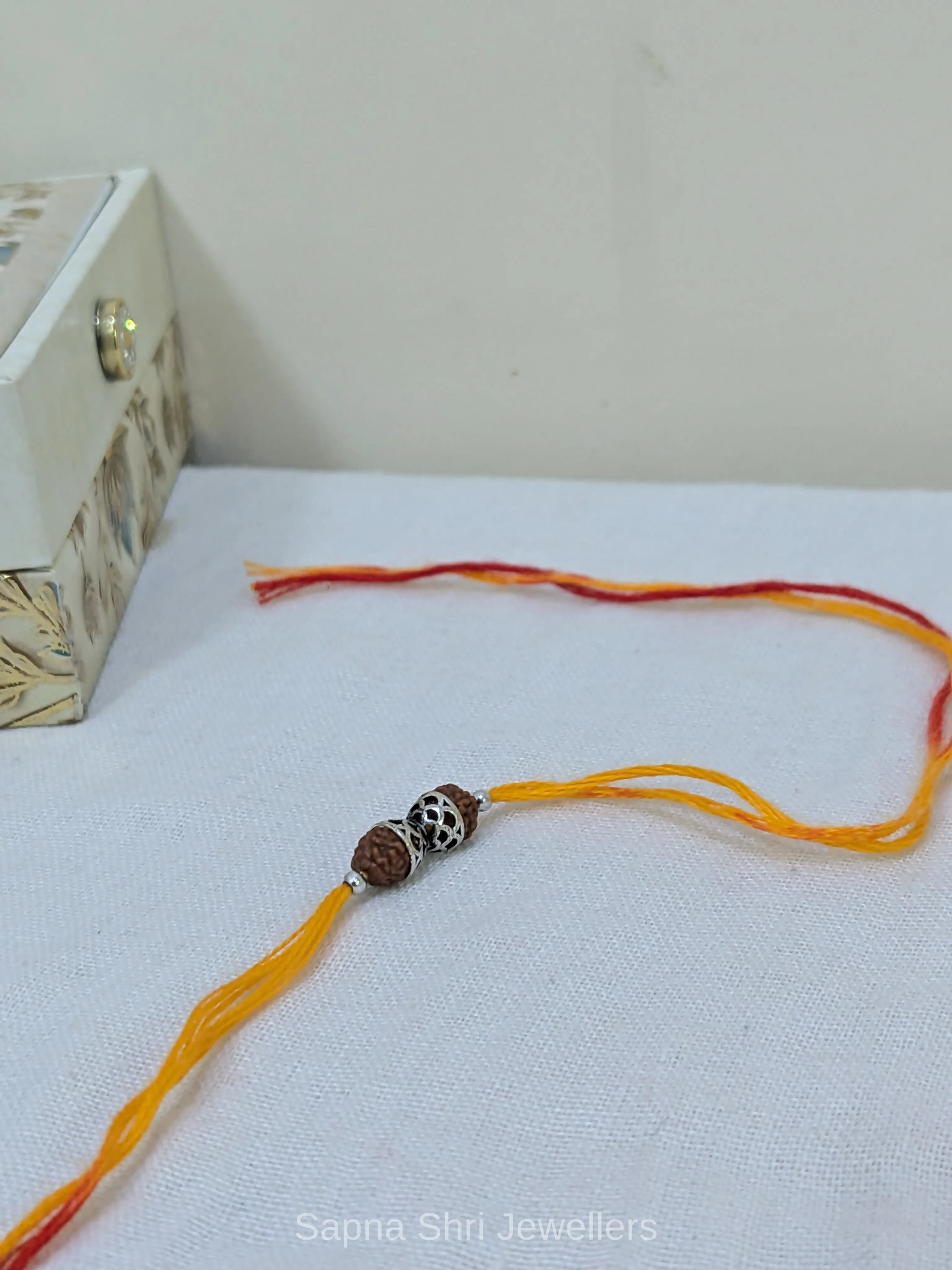 925 Silver Rudraksha Rakhi with Designer Silver Caps & Mauli Thread - Image 1 of 4 925 Silver Rudraksha Rakhi with Designer Silver Caps & Mauli Thread - View 1