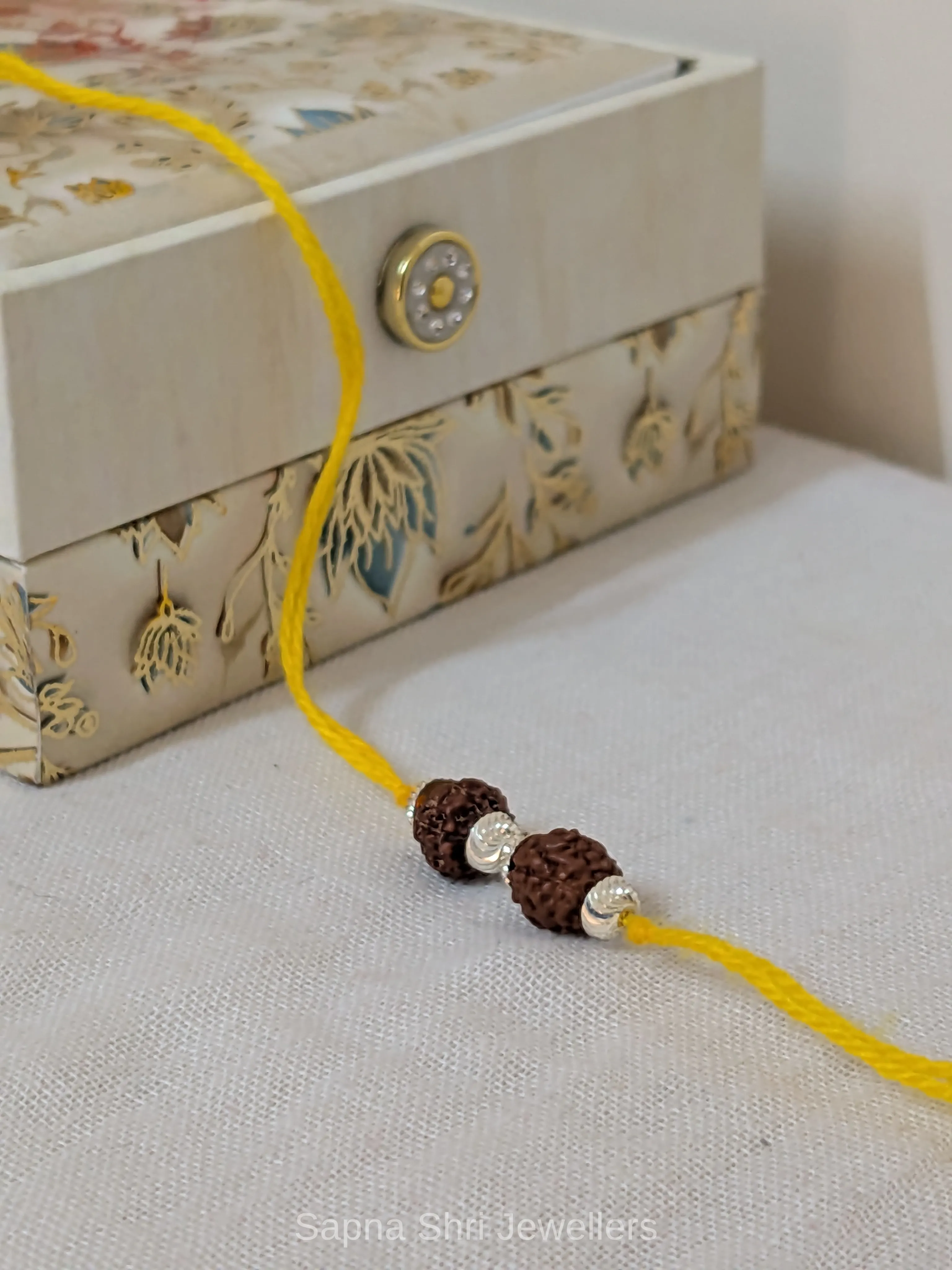 Rudraksha Silver Rakhi – Two Bead Spiritual Rakhi - Image 1 of 4 Rudraksha Silver Rakhi – Two Bead Spiritual Rakhi - View 1