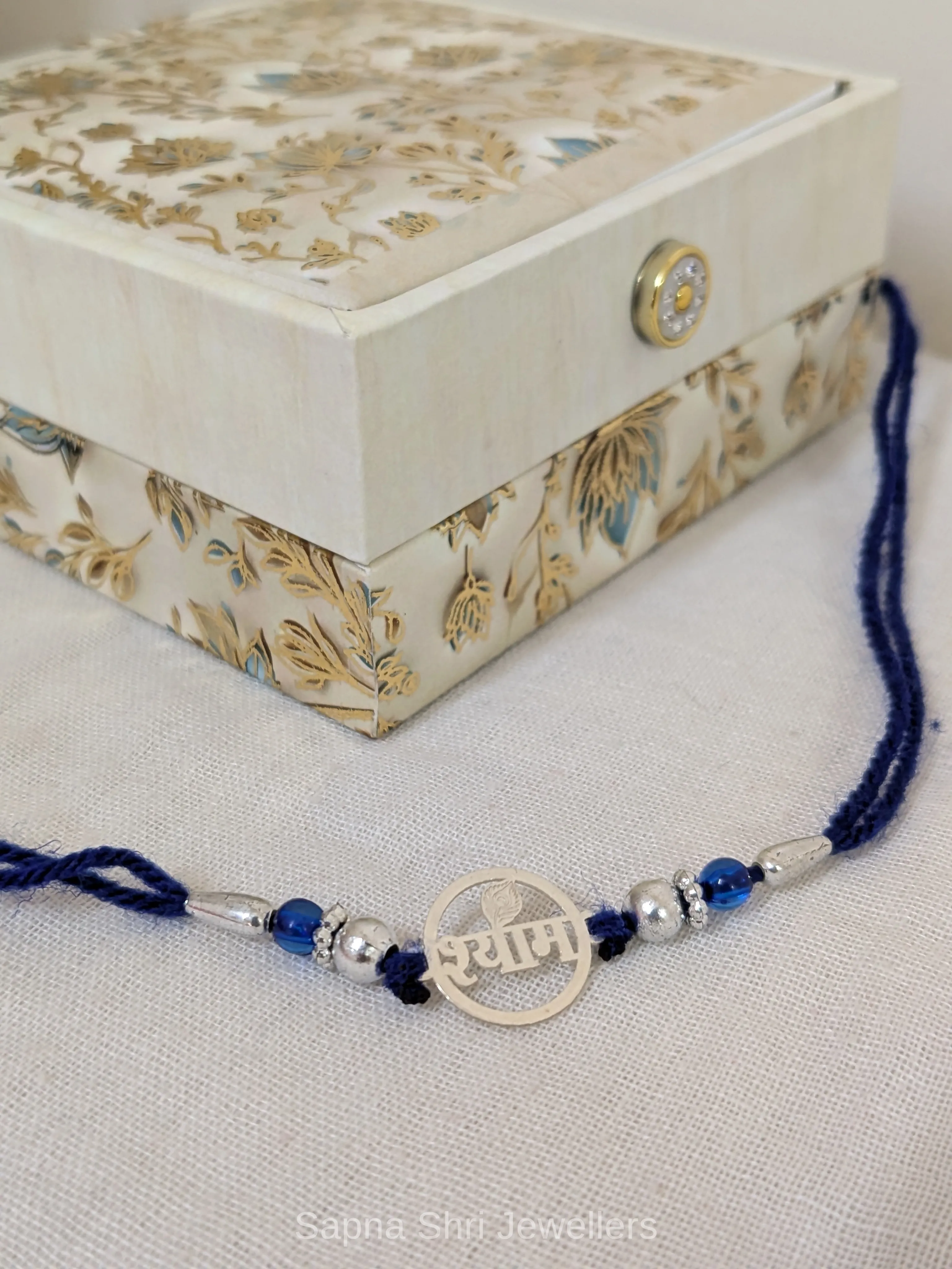 Shyam Silver Rakhi with Blue Beads & Traditional Thread - Image 1 of 4 Shyam Silver Rakhi with Blue Beads & Traditional Thread - View 1