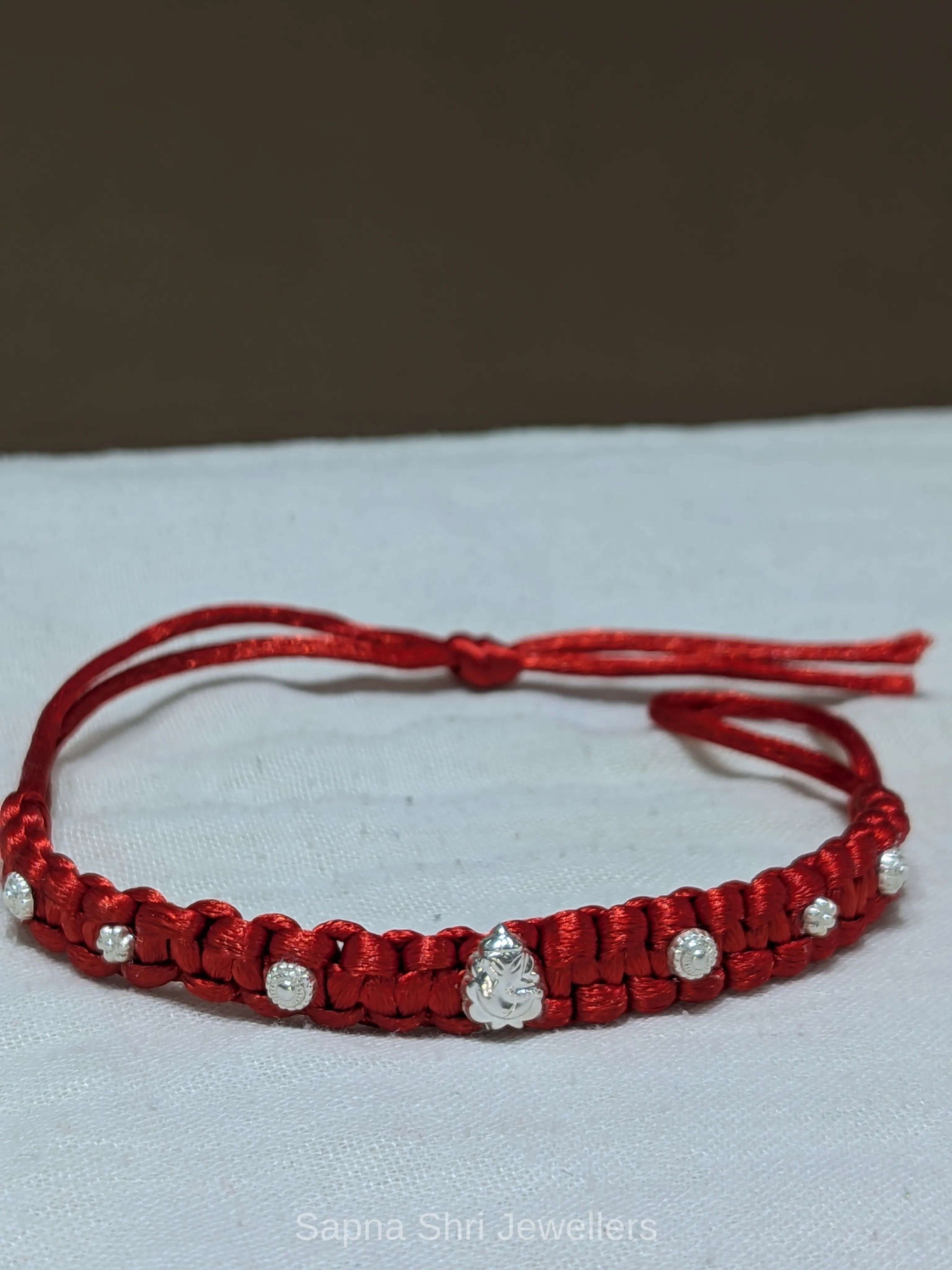 925 Silver Ganesha Braided Rakhi with Red Thread - Image 1 of 4 925 Silver Ganesha Braided Rakhi with Red Thread - View 1