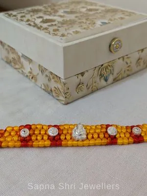 Ganesha Silver Rakhi with Red & Yellow Traditional Thread - Sapna Shri Jewellers