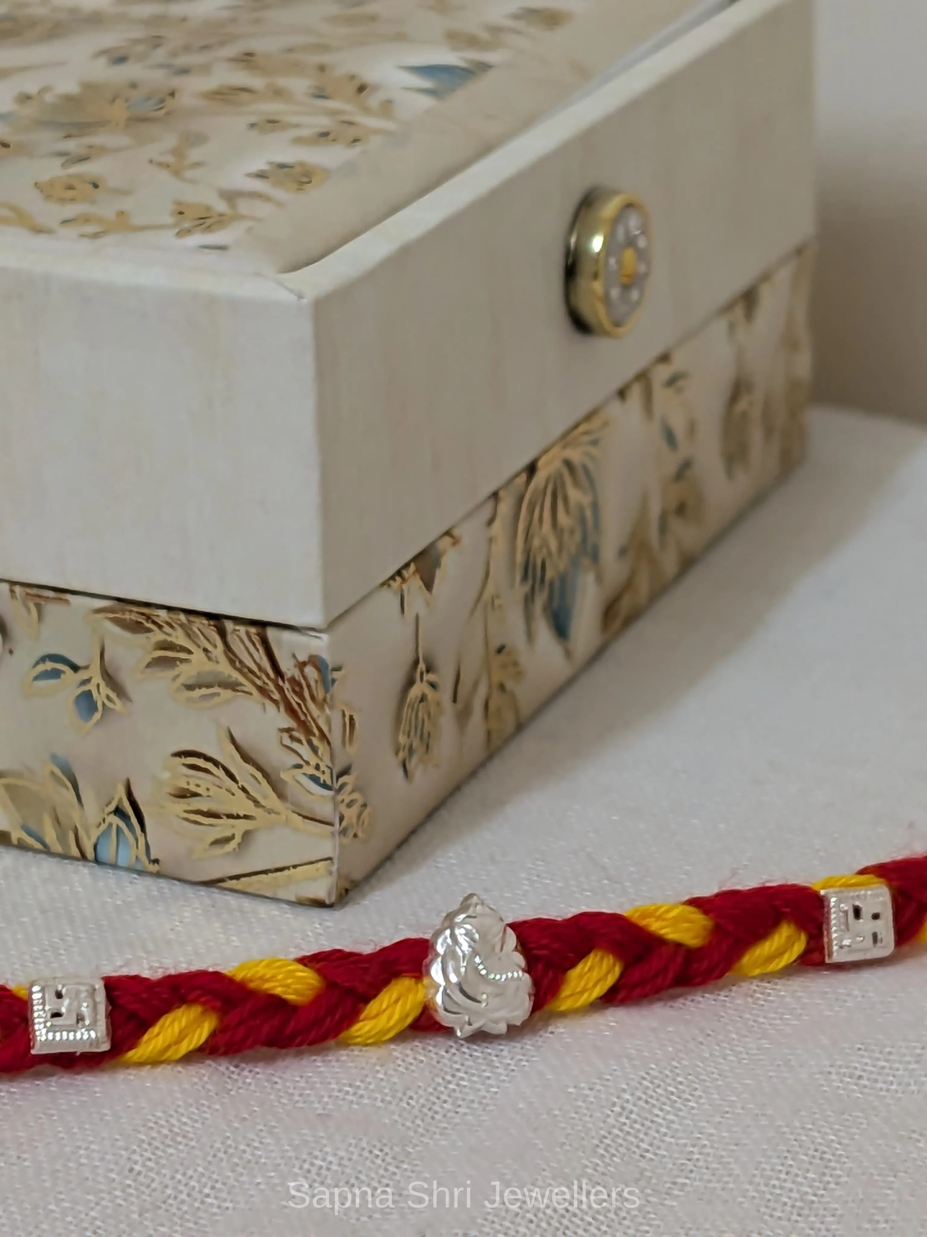Ganesh Silver Rakhi – Red & Yellow Mauli Rakhi for Brother thumbnail 2