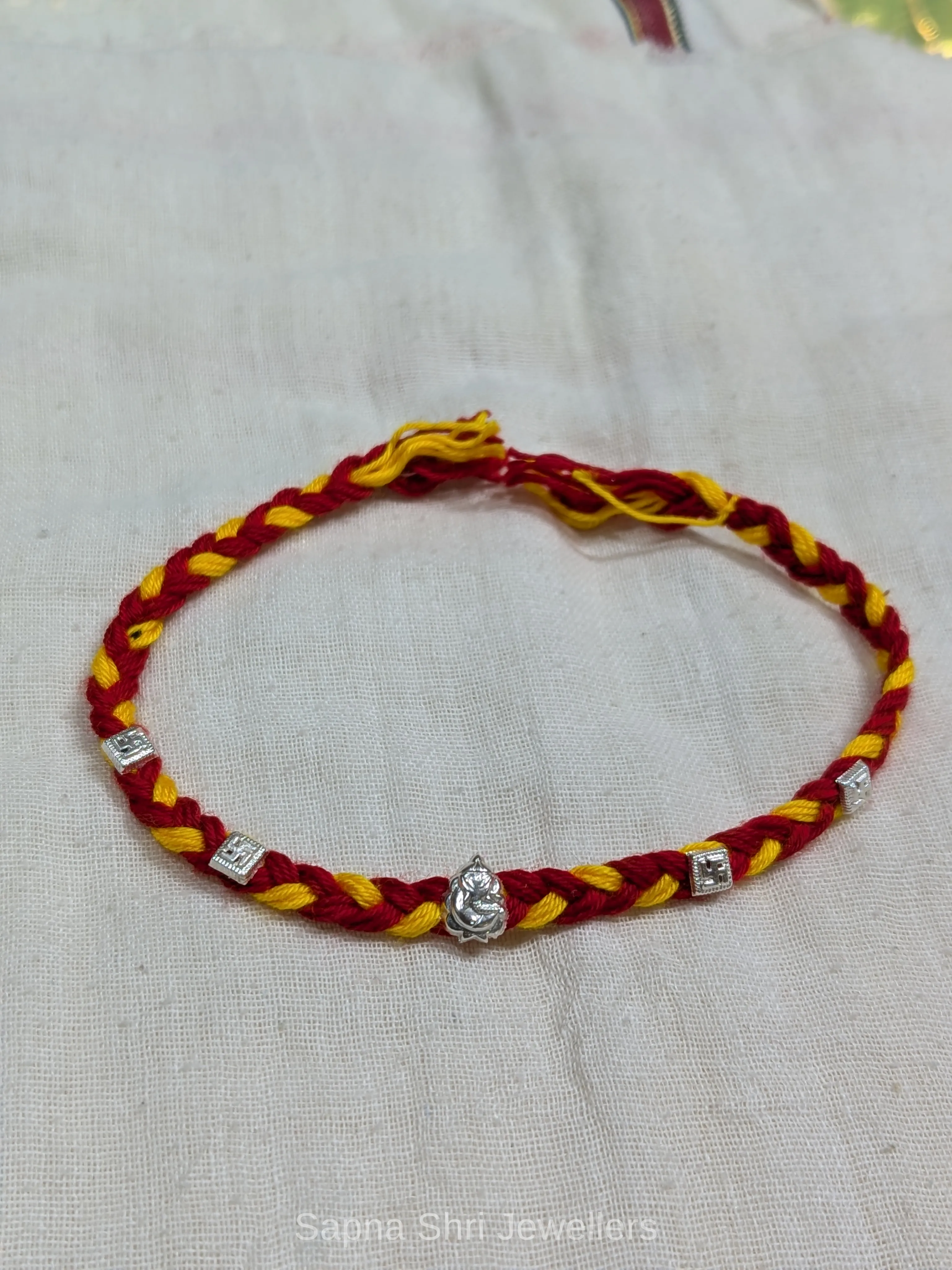 Ganesh Silver Rakhi – Red & Yellow Mauli Rakhi for Brother thumbnail 3