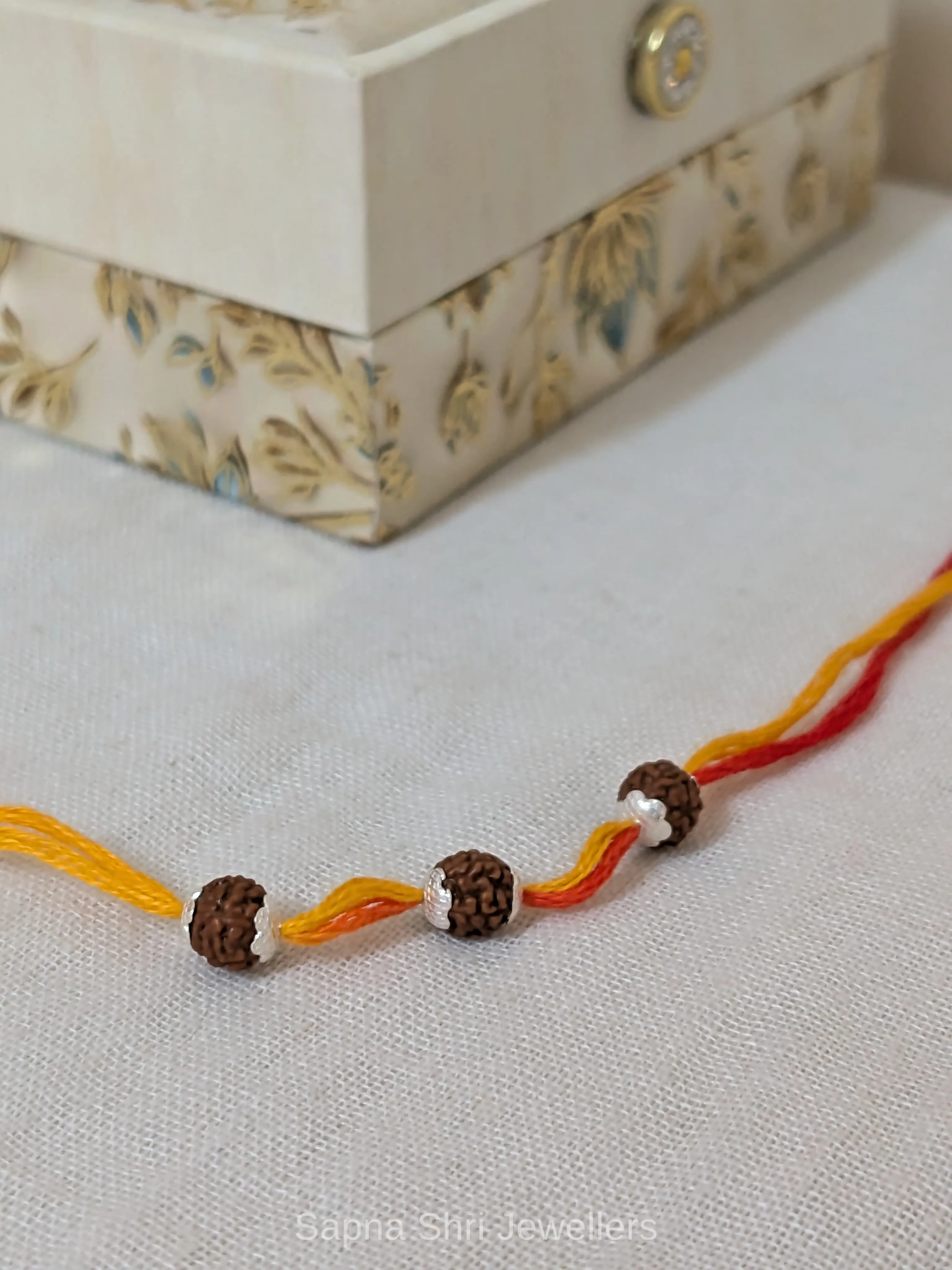 Three Rudraksha Silver Rakhi – Red & Yellow Spiritual Rakhi thumbnail 2