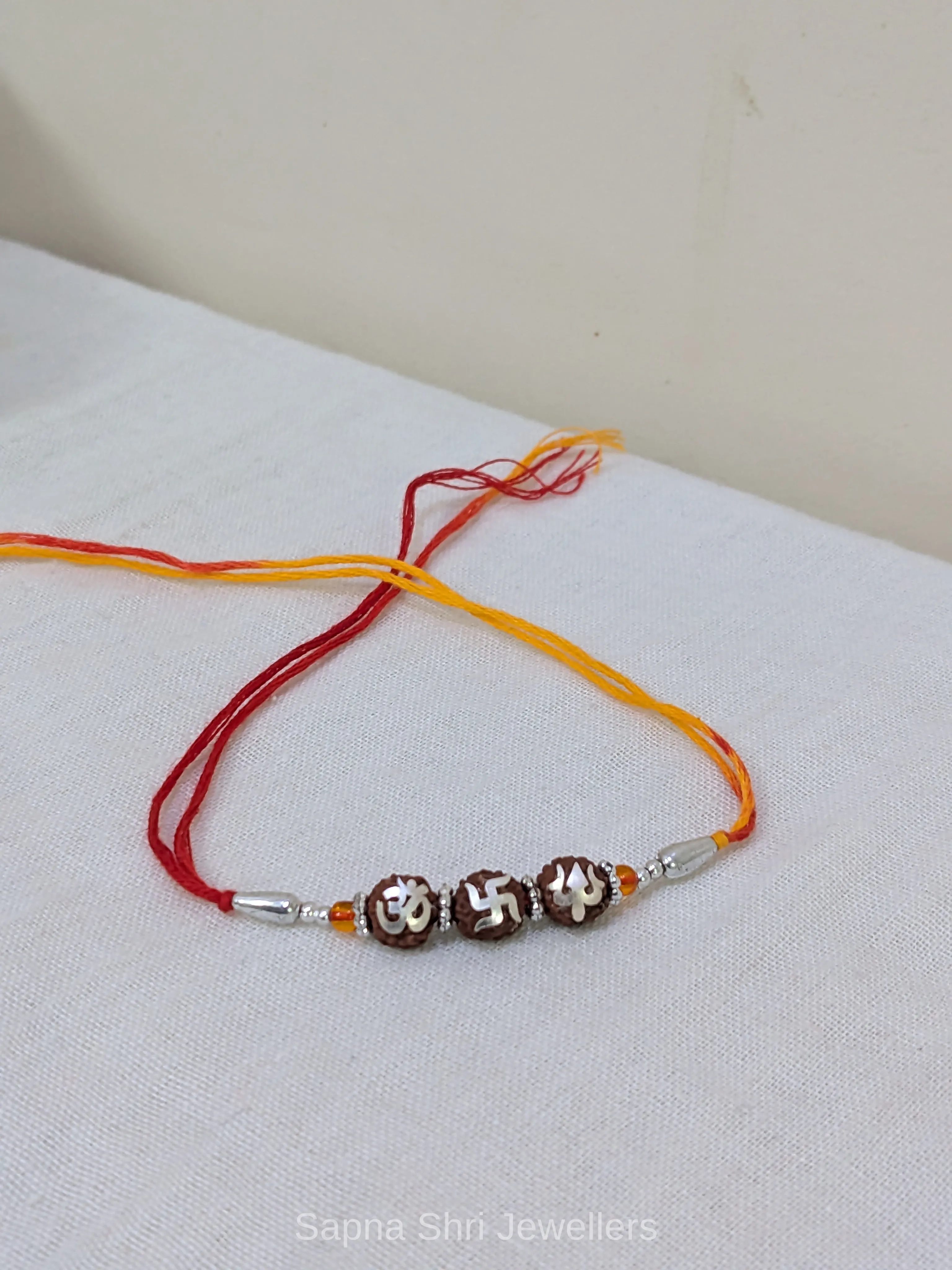 925 Silver Om Swastik Trishul Rudraksha Rakhi with Red & Yellow Mauli thumbnail 3