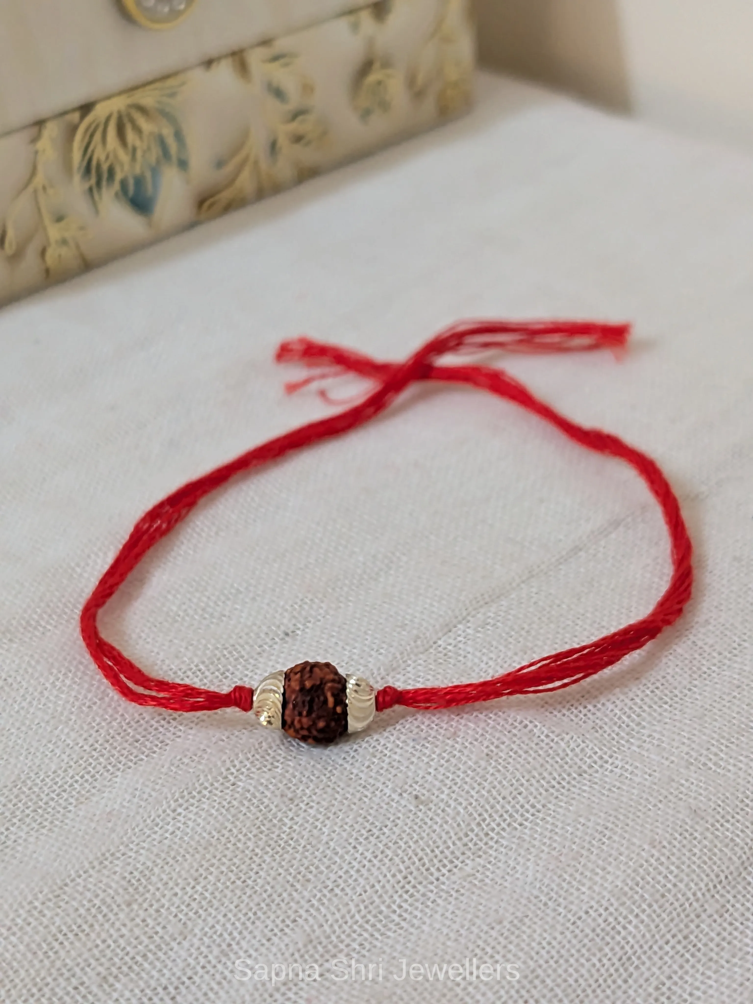 Single Rudraksha Silver Rakhi – Minimal Red Thread Rakhi thumbnail 3