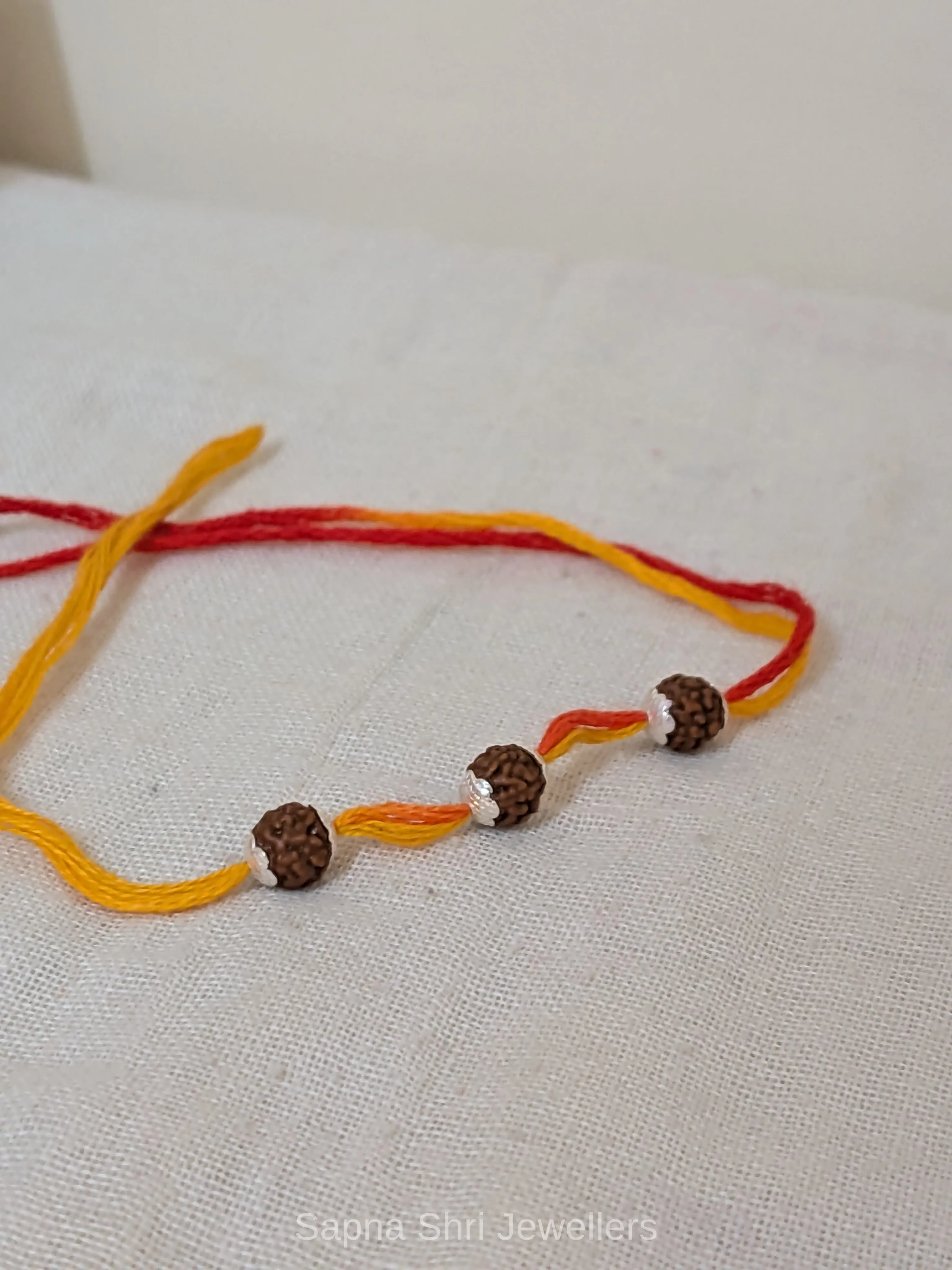 Three Rudraksha Silver Rakhi – Red & Yellow Spiritual Rakhi thumbnail 3