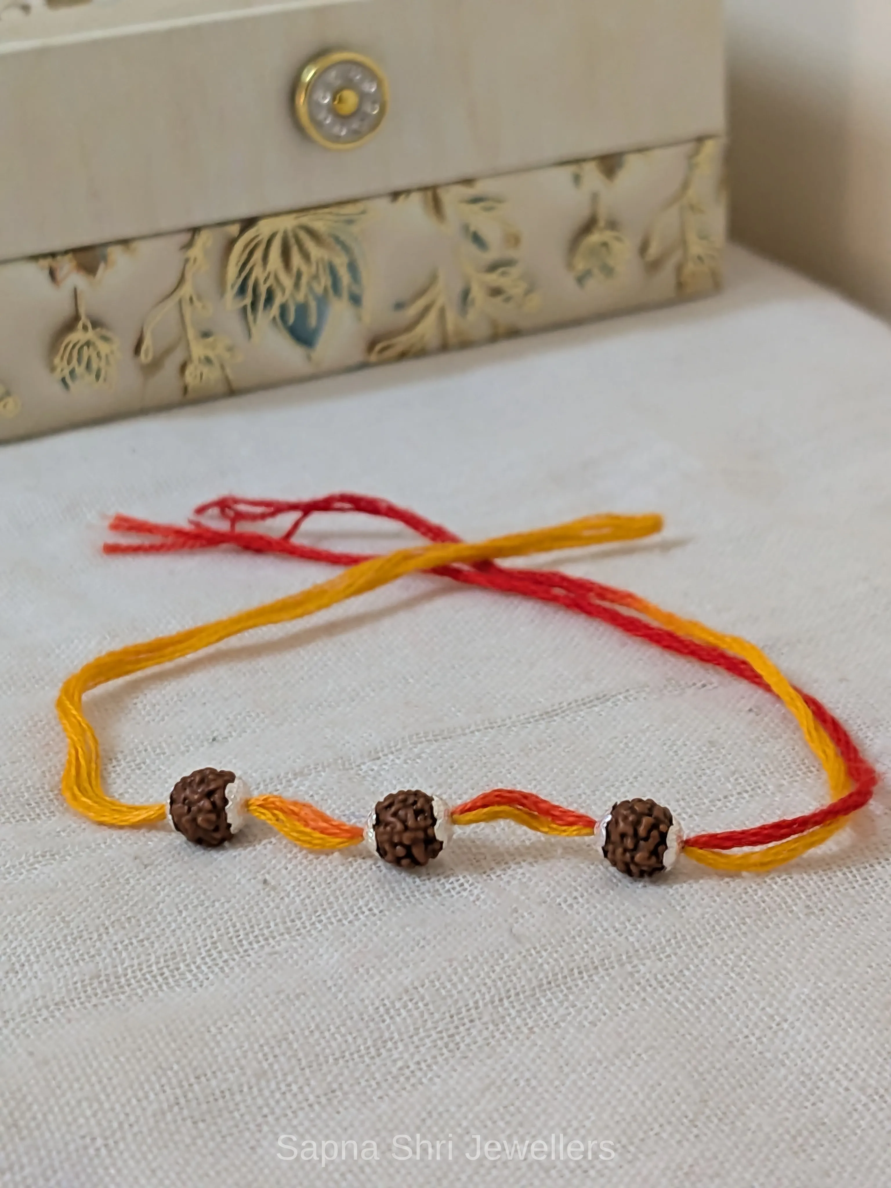 Three Rudraksha Silver Rakhi – Red & Yellow Spiritual Rakhi thumbnail 4