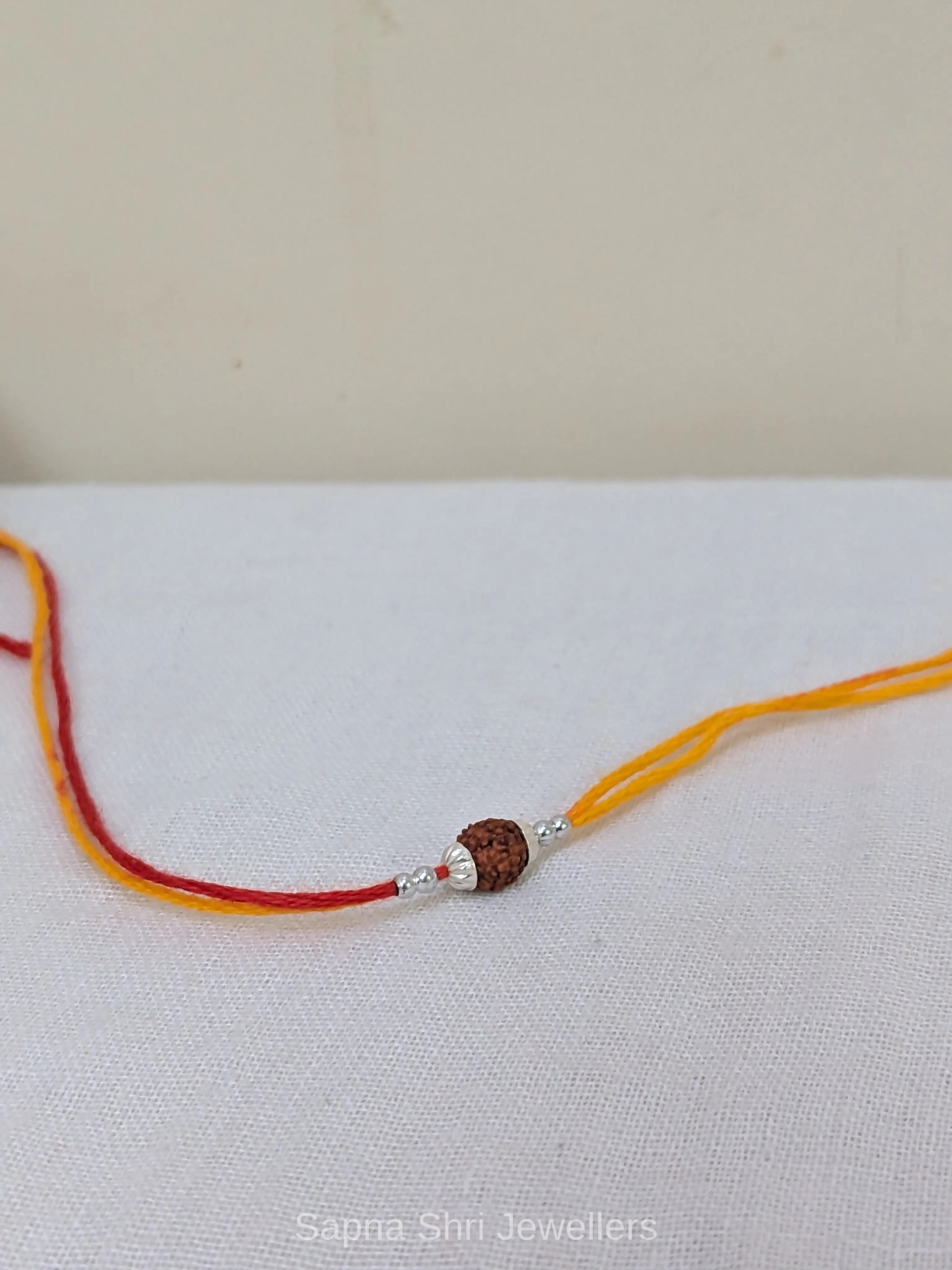 925 Silver Rudraksha Rakhi with Yellow & Red Mauli Thread thumbnail 4