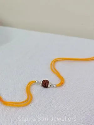 925 Silver Minimal Rudraksha Rakhi with Silver Beads & Mauli Thread 925 Silver Minimal Rudraksha Rakhi with Silver Beads & Mauli Thread