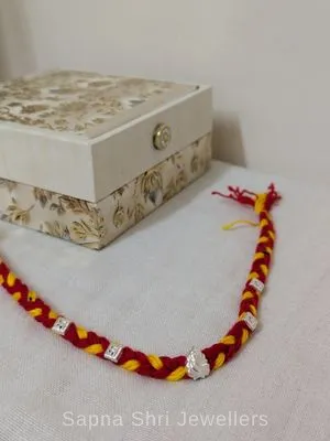Ganesh Silver Rakhi – Red & Yellow Mauli Rakhi for Brother