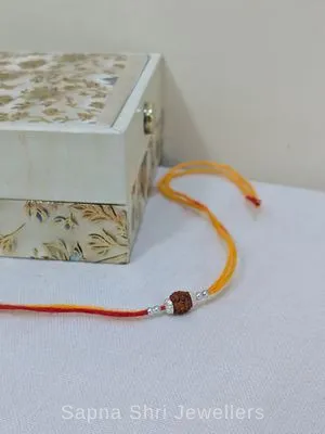 925 Silver Rudraksha Rakhi with Yellow & Red Mauli Thread 925 Silver Rudraksha Rakhi with Yellow & Red Mauli Thread